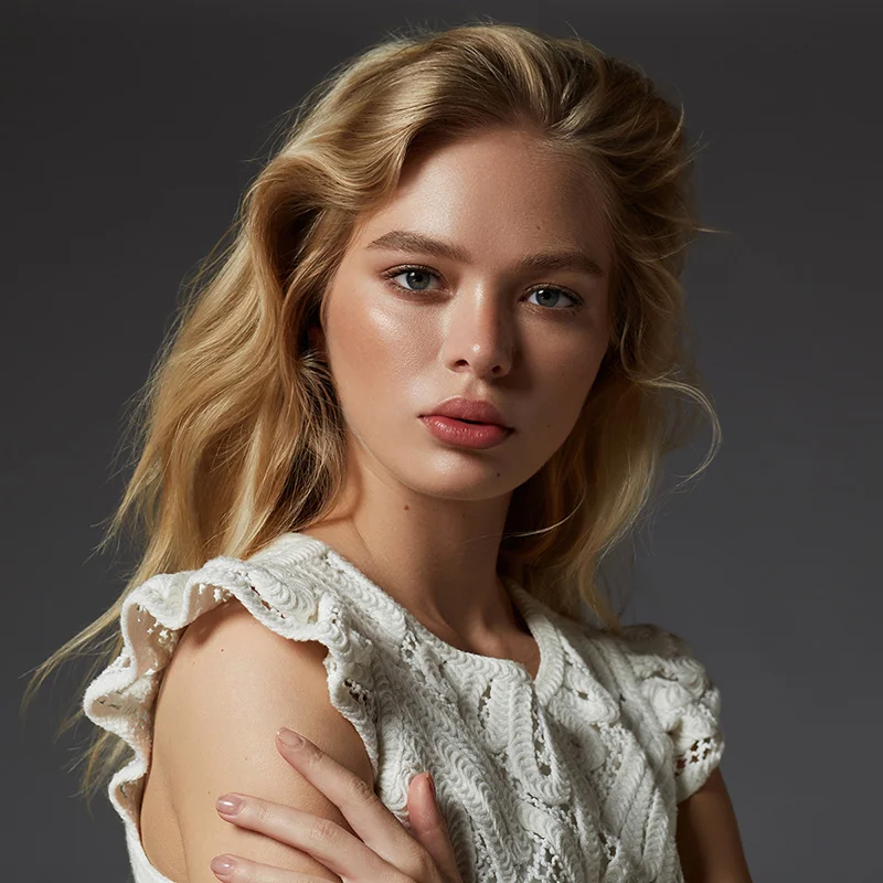 Featured beauty retouching portfolio highlight showing a blonde model with flawless glowing skin and soft natural makeup