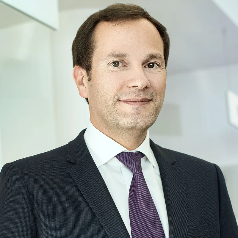 Featured business portrait retouching portfolio highlight showing a corporate executive in a dark suit and purple tie