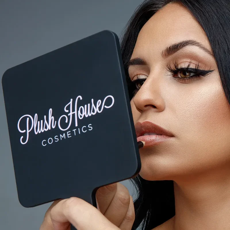 Featured commercial advertising retouching portfolio highlight showing a cosmetics model applying lipstick in front of a mirror