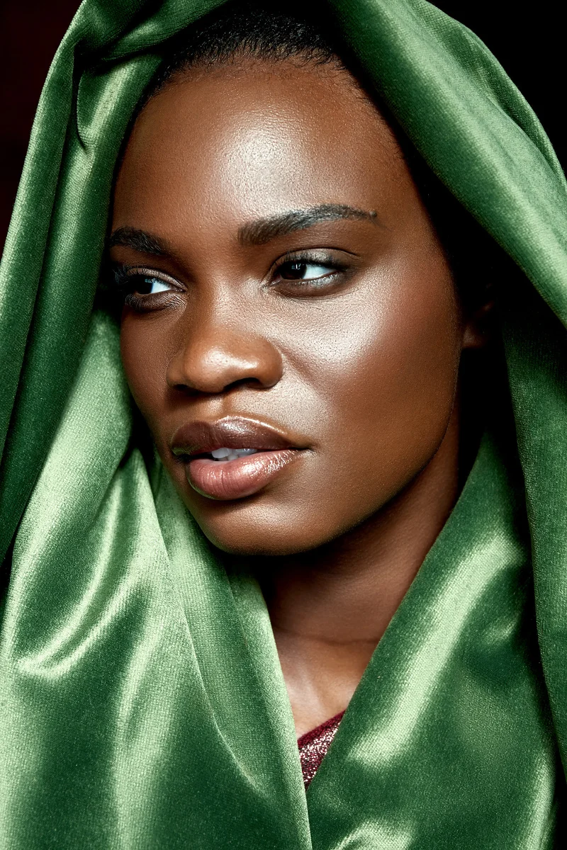 High-end portrait retouching showing a Black model with a green velvet headwrap