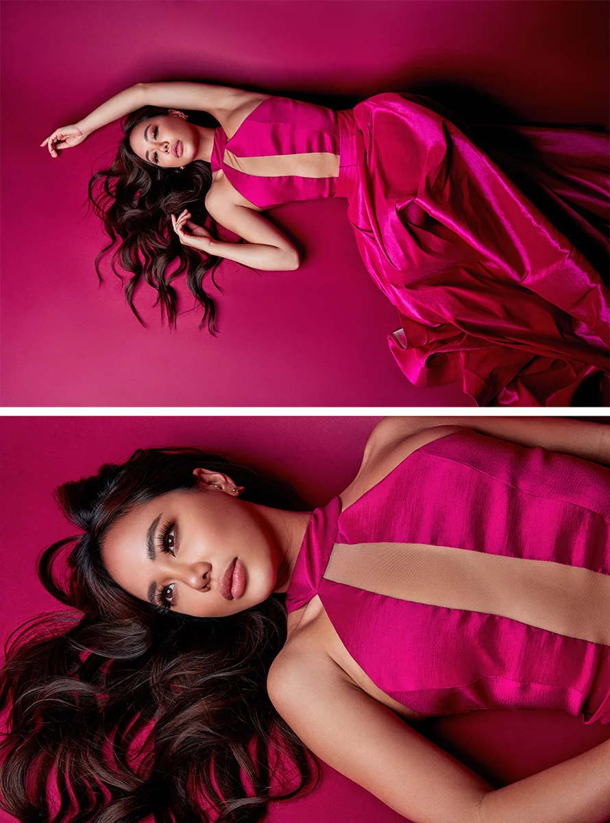 High-end close-up fashion portrait retouching of a female model lying down on a magenta background wearing a magenta dress